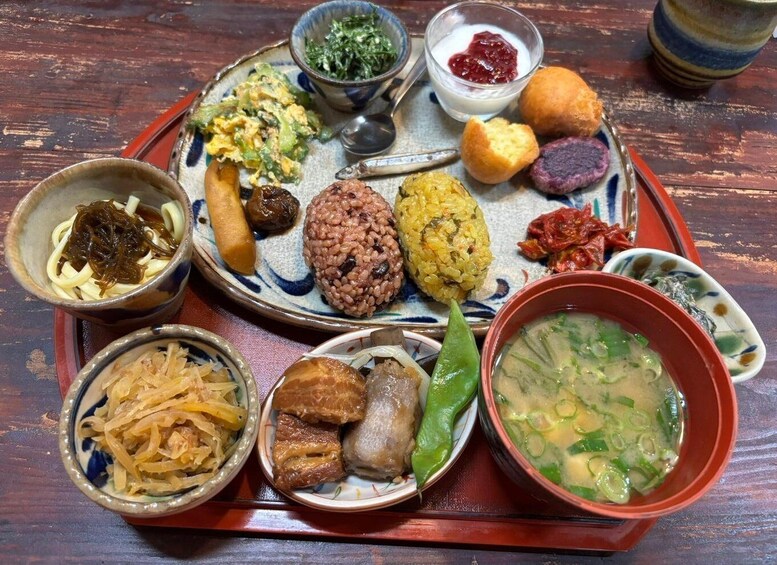 A traditional Japanese meal with various dishes including rice, noodles, and soup. 3