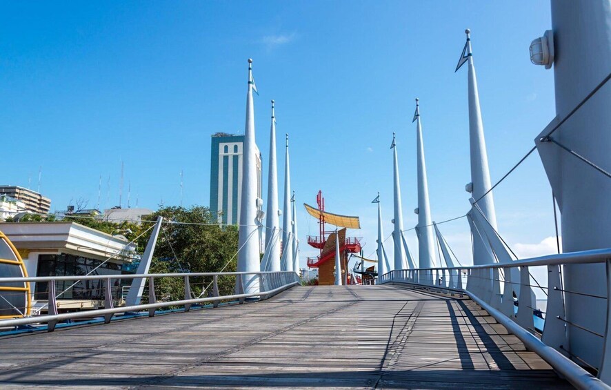 A pedestrian bridge with a modern design, featuring a central walkway and railings on both sides. 4