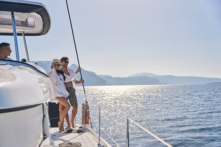A sailboat on calm waters with a clear sky and distant mountains. 3