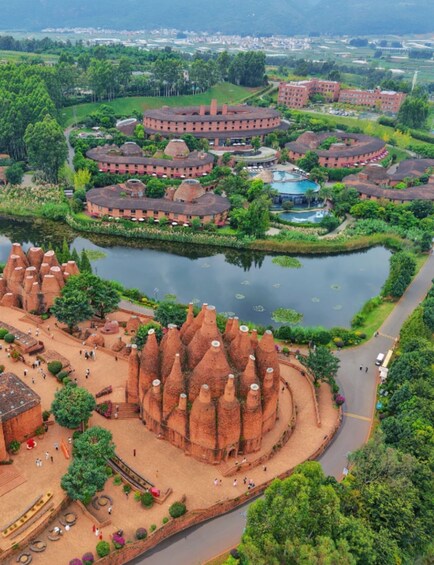 A large, circular building with a central pond surrounded by a landscaped garden and a distinctive conical structure. 1