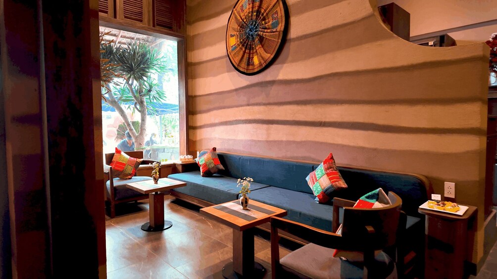 A cozy indoor seating area with a sofa, a coffee table, and a decorative wall piece. 3