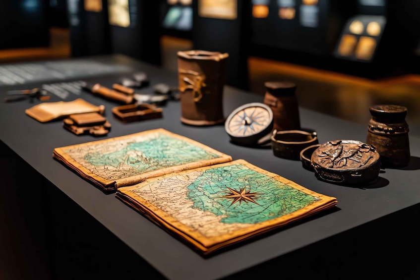 An antique map with a compass rose, surrounded by vintage navigation instruments on a display table. 3