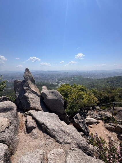 A rocky landscape with a city in the distance. 3