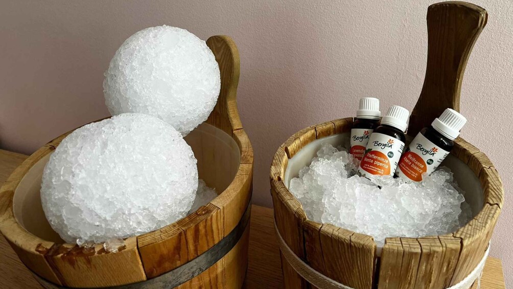 Two wooden buckets filled with ice and containing bottles of Bergina essential oils. 4