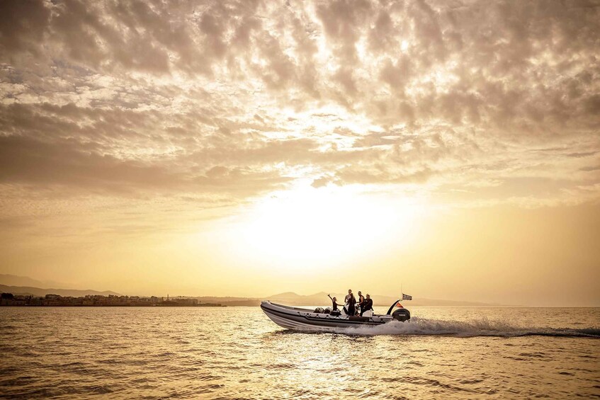 A boat with people on the water during sunset. 3