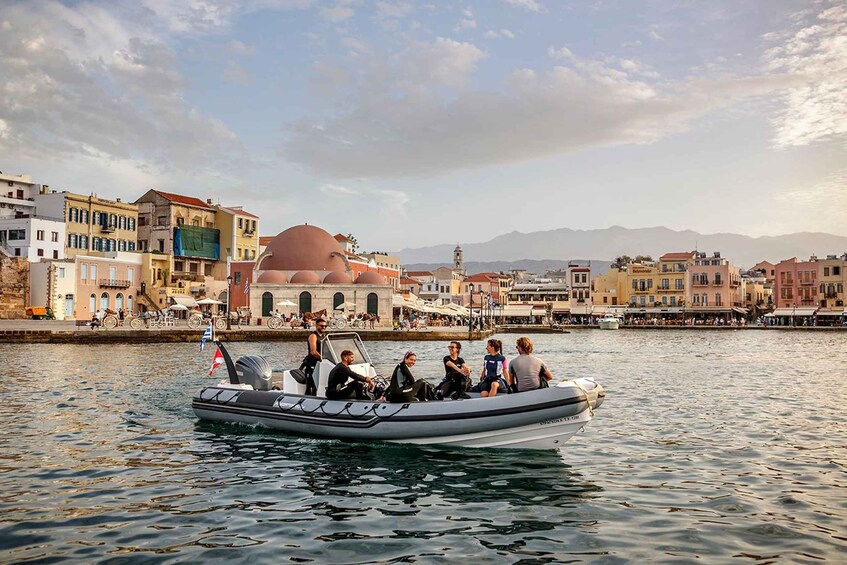 A boat with passengers on a calm river, surrounded by historic buildings and a prominent dome structure in the background. 1
