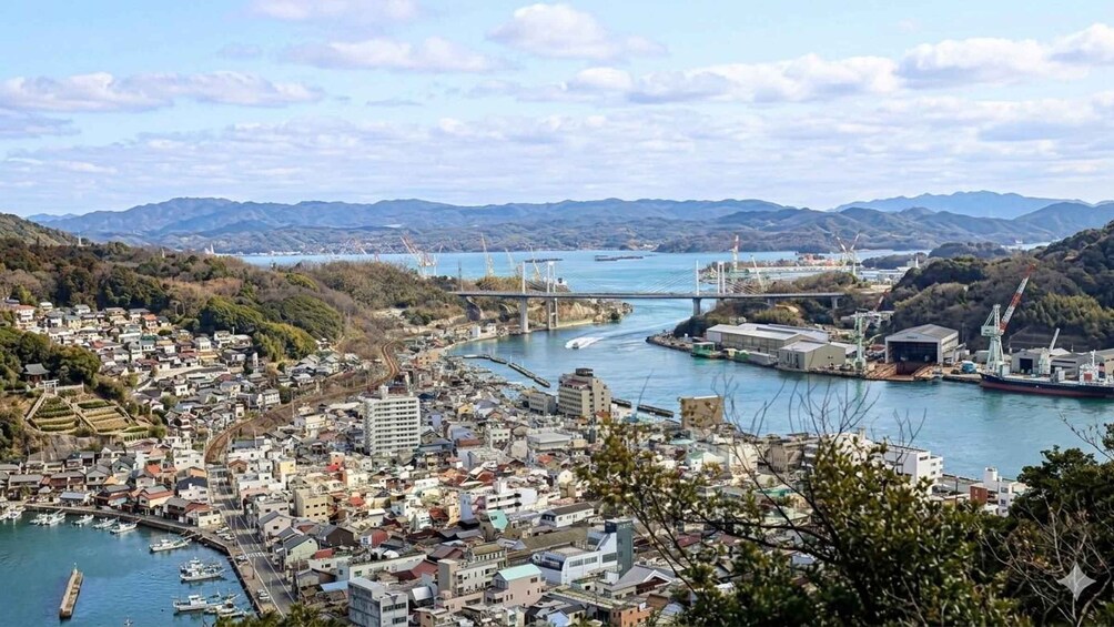 A coastal city with a bridge, port, and mountains in the background. 4