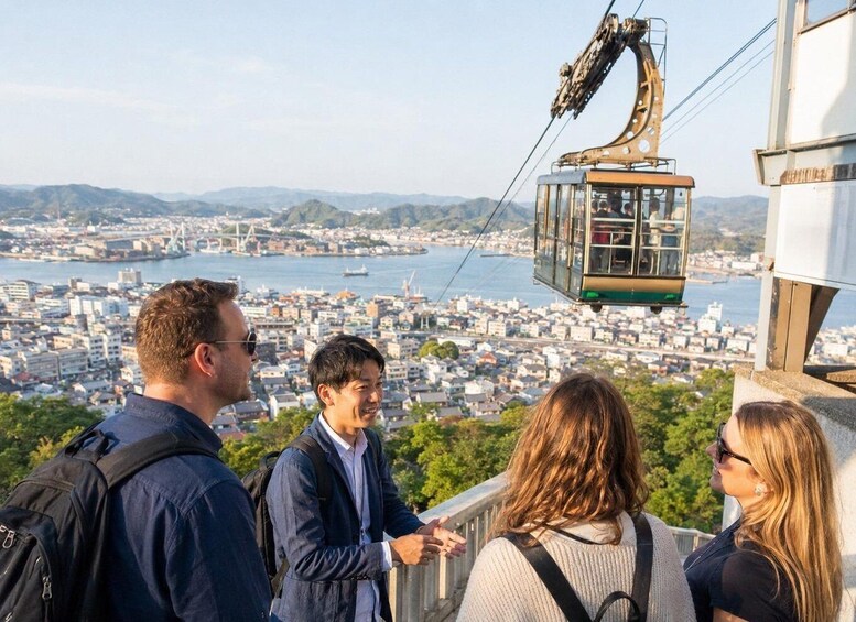 A cable car with passengers overlooking a cityscape and a body of water. 2
