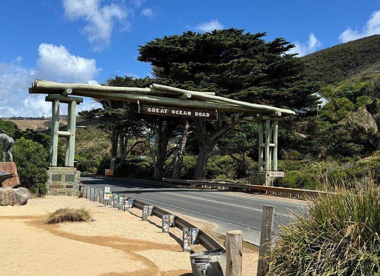 A road sign for Great Ocean Road with a wooden archway and a statue. 5
