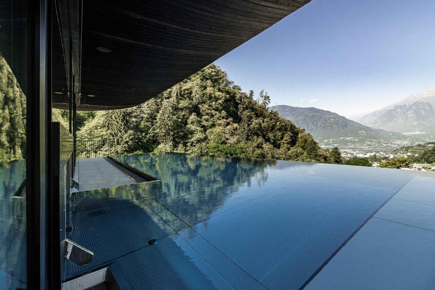 A clear blue sky, a mountain range, and a reflective pool. 3