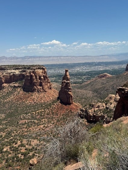 A desert landscape with prominent rock formations and sparse vegetation. 4