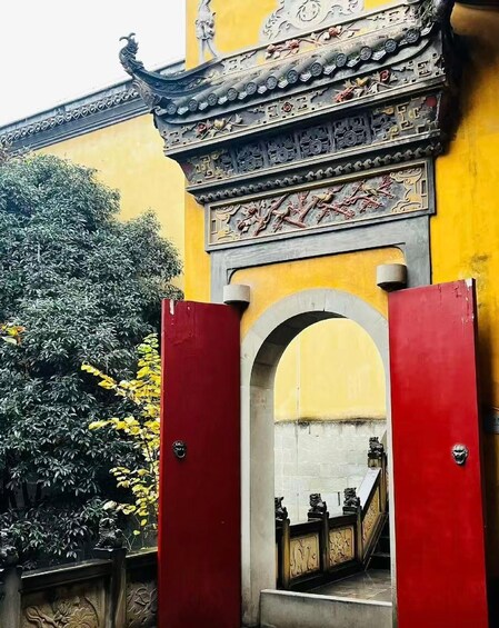 A traditional gate with ornate carvings and a red archway. 2