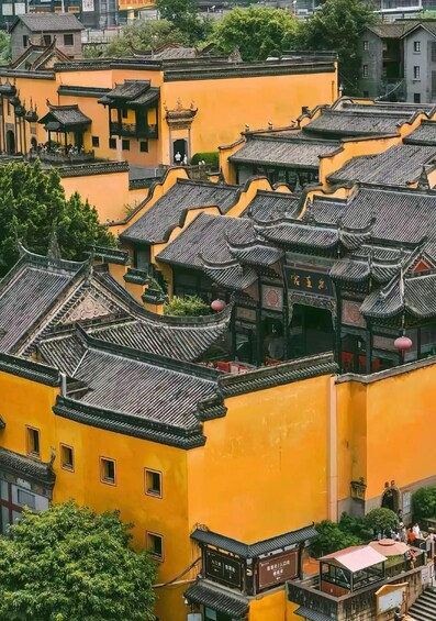 A traditional yellow building with ornate roofs and a pagoda-style structure. 3
