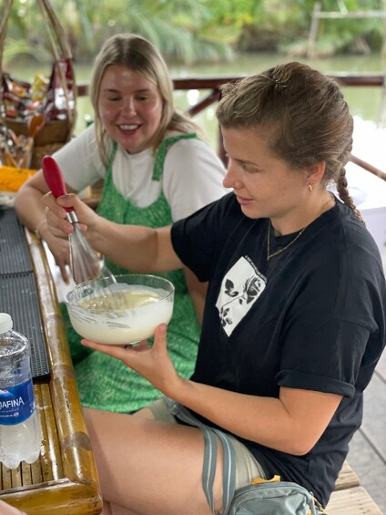 Two people preparing a drink with a blender. 4