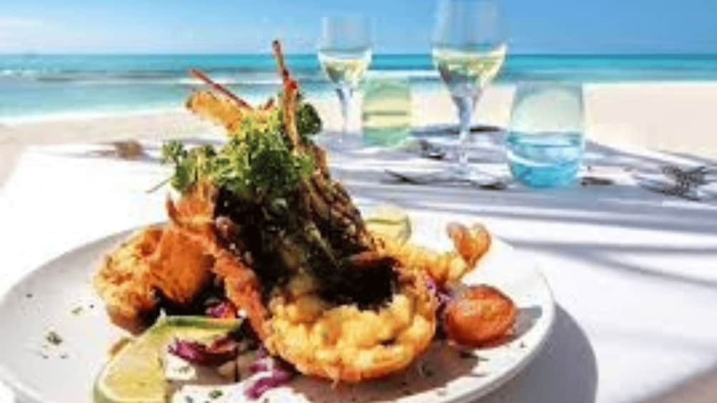 A seafood dish on a plate with a beach and ocean in the background. 2