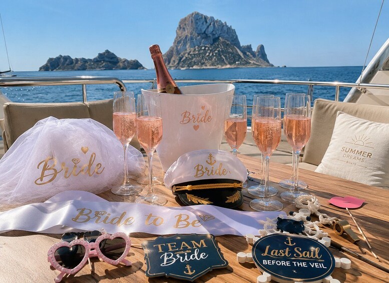A boat deck with a 'Bride to Be' banner, champagne glasses, a 'Team Bride' sign, and a 'Last Sail Before the Veil' sign. 3
