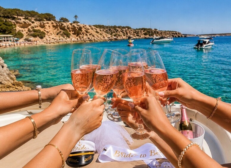 A group of people toasting with champagne glasses on a boat, with a coastal landscape and boats in the background. 5