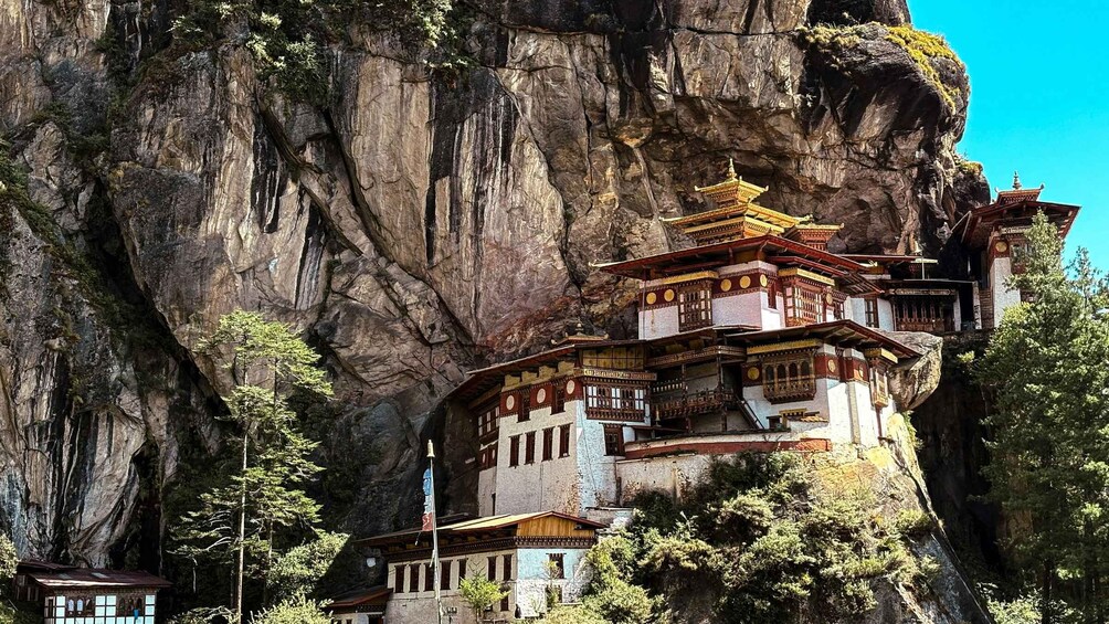 A traditional multi-tiered temple nestled against a cliff. 5
