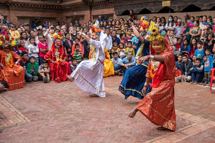 A traditional dance performance in front of an audience. 3
