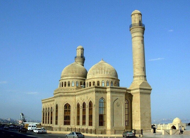A large mosque with two domes and a tall minaret. 3