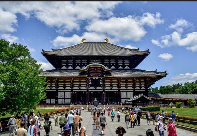 Perinteinen japanilainen rakennus, jossa on suuri avoin sisäpiha ja vierailijoita. 1