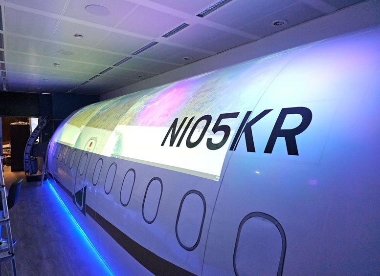 A futuristic aircraft interior with the registration 'NI05KR' and a digital display. 5
