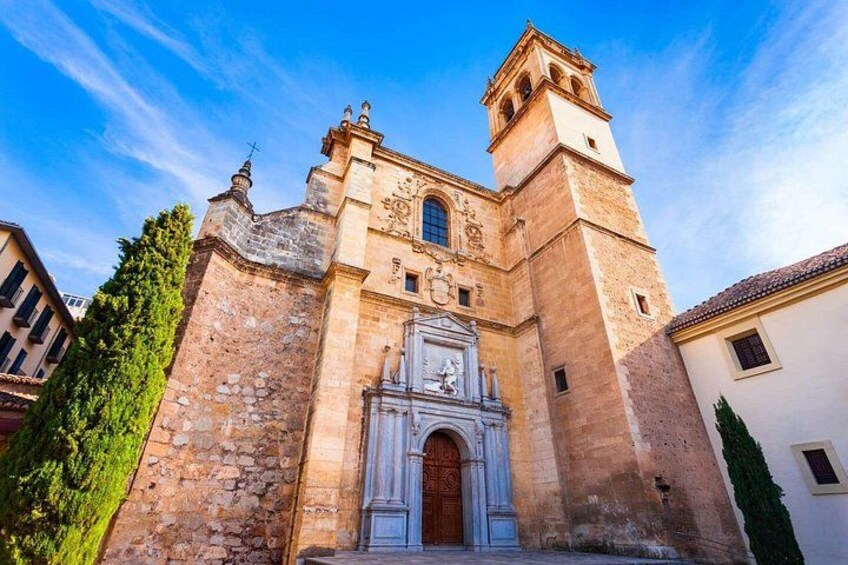 A historic church with a bell tower, a large arched entrance, and a stone facade. 2