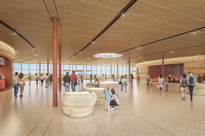 A spacious indoor area with a high ceiling, large windows, and a central circular skylight. 2