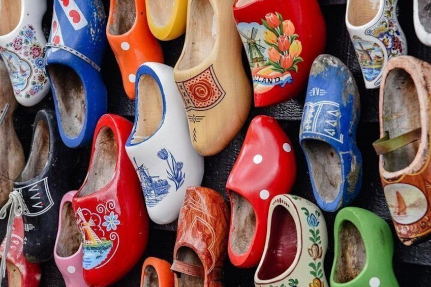 A collection of colorful wooden clogs with various designs. 5