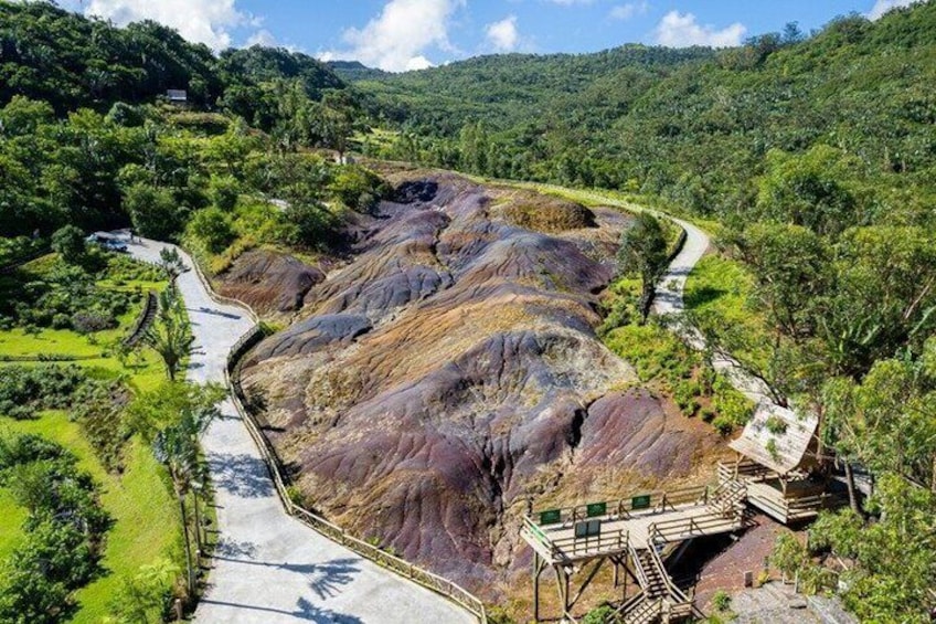 A winding road through a mountainous landscape with a bridge over a river. 5