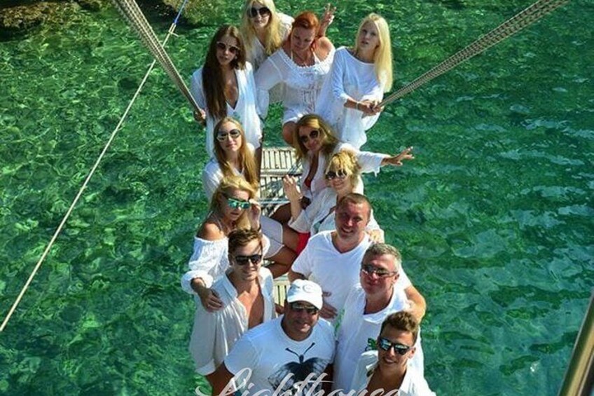 A group of people on a boat in clear water. 4