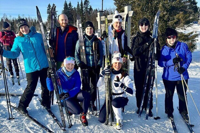 A group of people with skis and poles in a snowy setting. 5