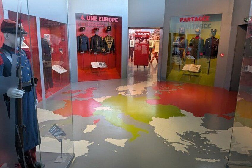 A mannequin in military uniform, a map with colored regions, and a storefront with mannequins in winter clothing. 3