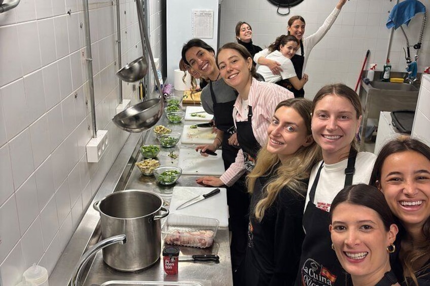 A group of people in a kitchen preparing food. 2