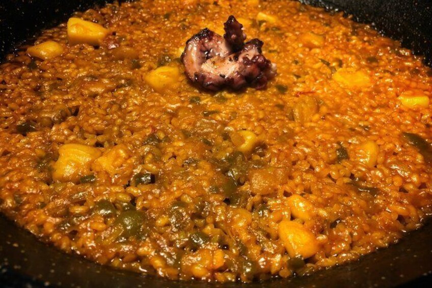 A close-up of a hearty stew with chunks of meat and vegetables in a pan. 3