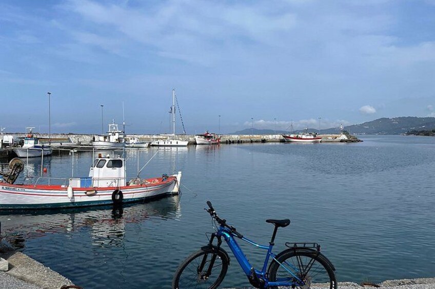 A harbor with boats, a bicycle, and a calm water body. 3