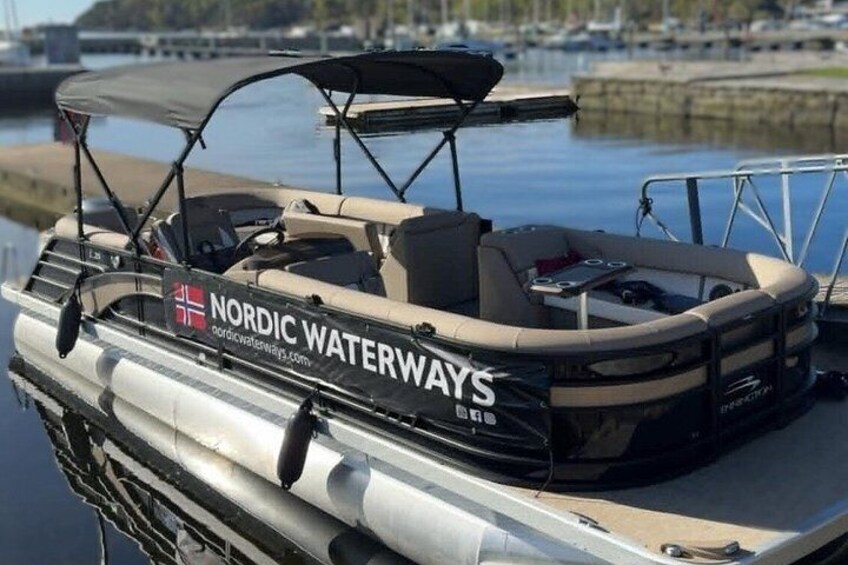 A boat with 'Nordic Waterways' branding docked at a marina. 2