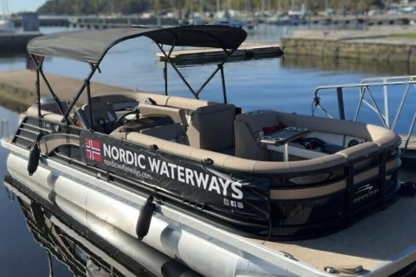 A boat with 'Nordic Waterways' branding docked at a marina. 2