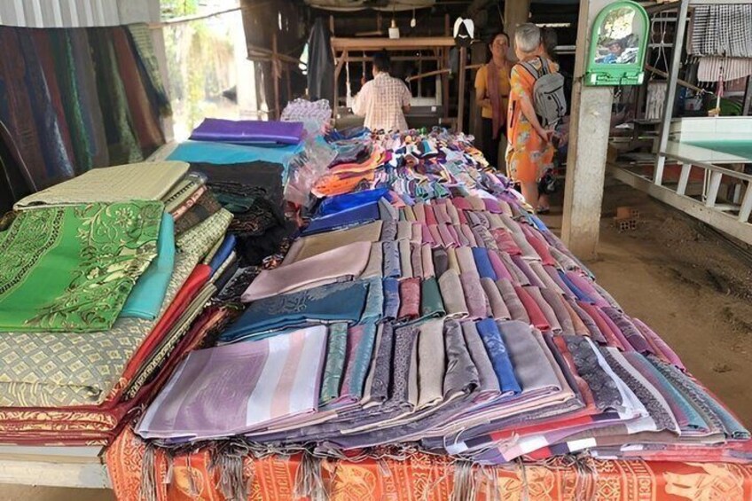 A market stall with various fabrics displayed. 5