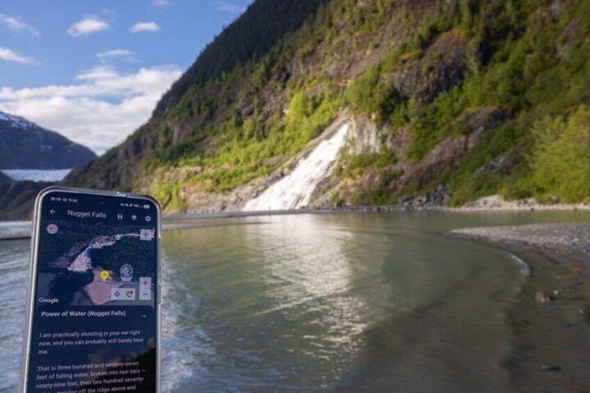 A smartphone displaying a map of Nugget Falls with a view of a river and mountains in the background. 4