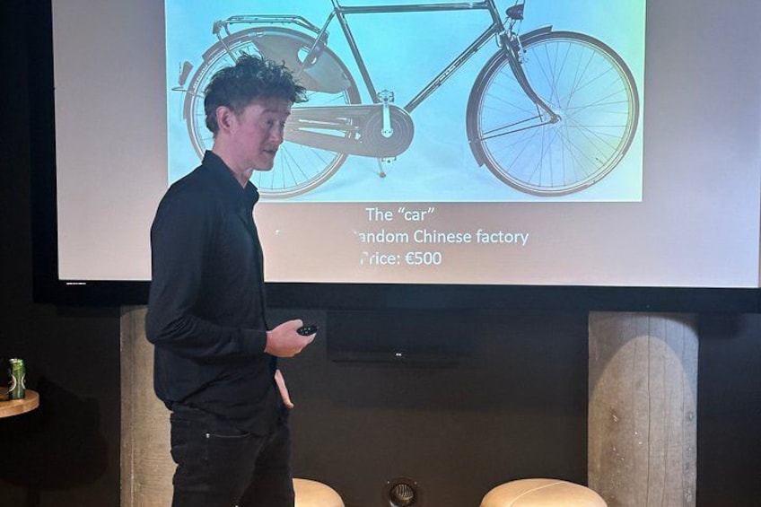 A person presenting a bicycle with a price tag of €500. 2