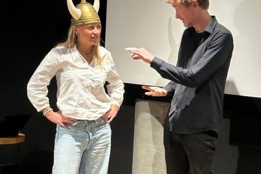 A person gesturing while another stands with hands on hips. 1