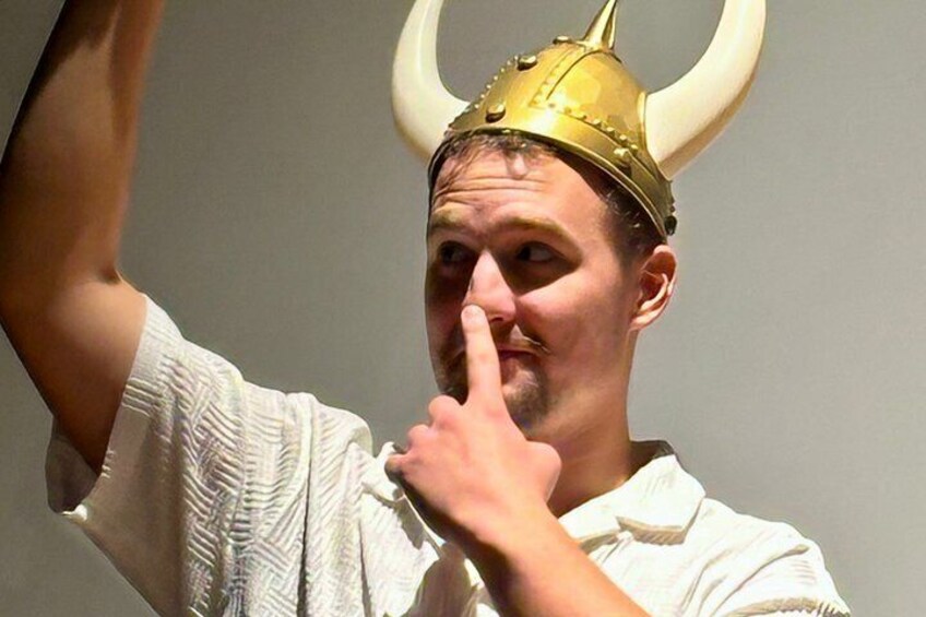 A person wearing a horned helmet and a white shirt. 3