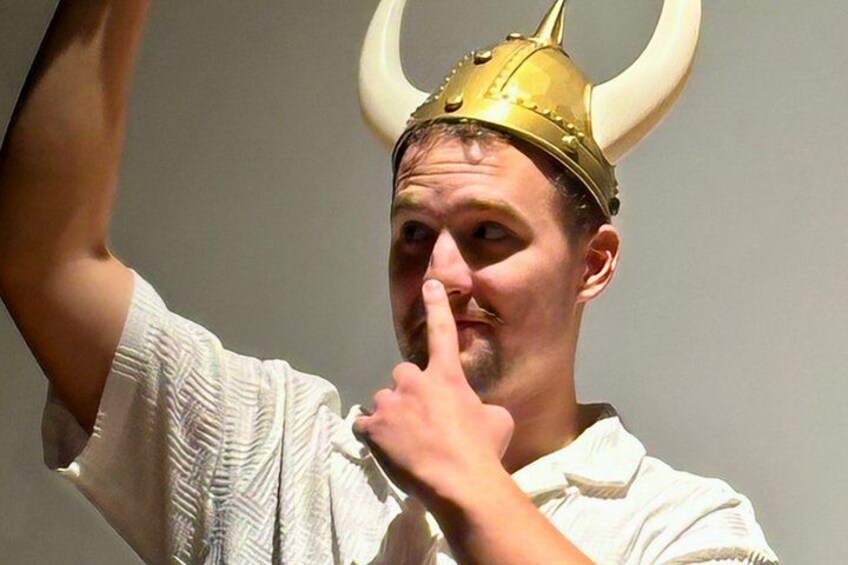 A person wearing a horned helmet and a white shirt. 3