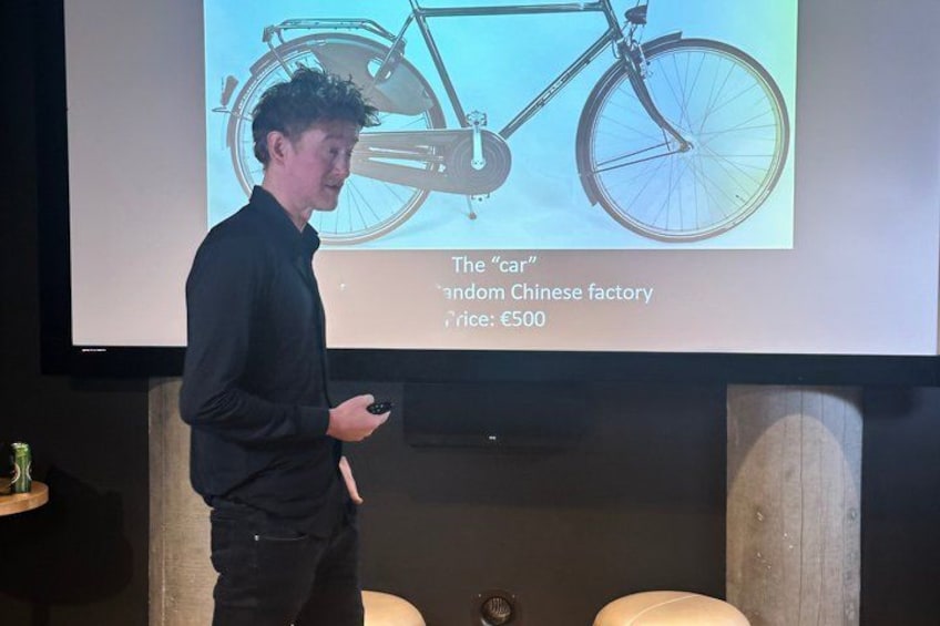 A person presenting a bicycle with a price tag of €500. 2