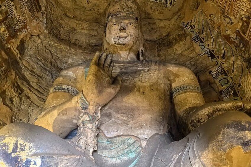 A large, intricately carved statue with detailed patterns and inscriptions. 4