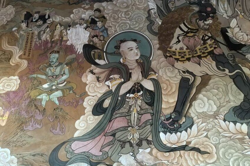 A mural with a central figure in traditional attire, surrounded by smaller figures and floral patterns. 5