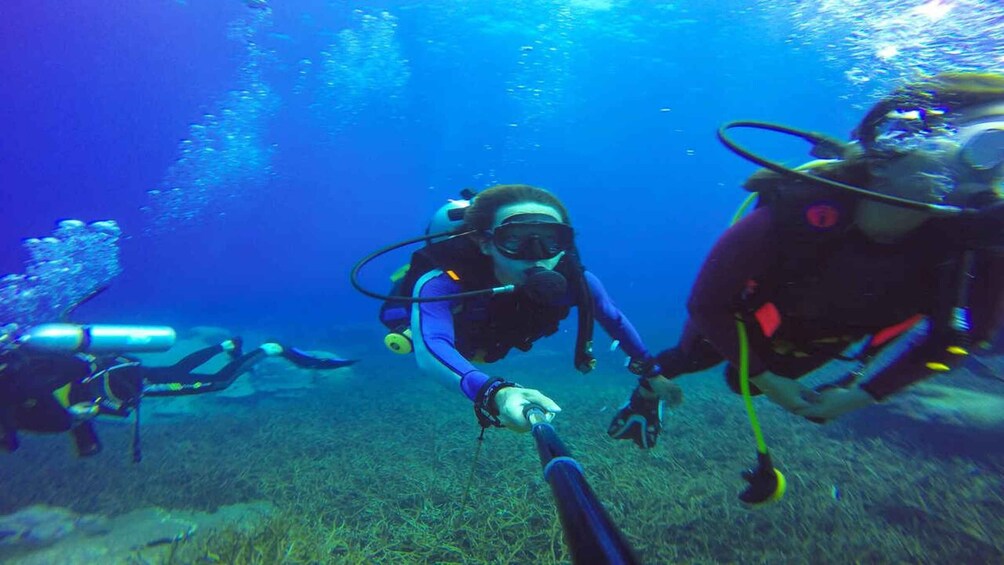 Two scuba divers underwater with their equipment. 2