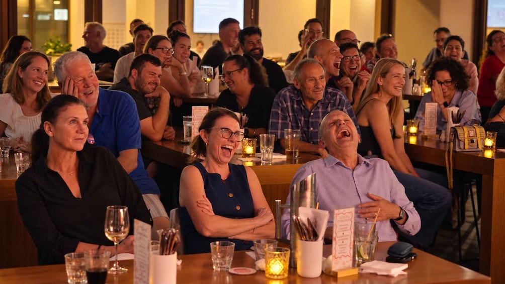A group of people seated at a table in a restaurant. 2