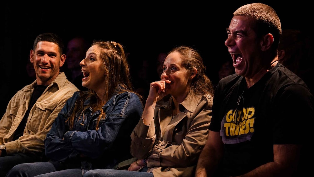 A group of people seated in a theater. 4